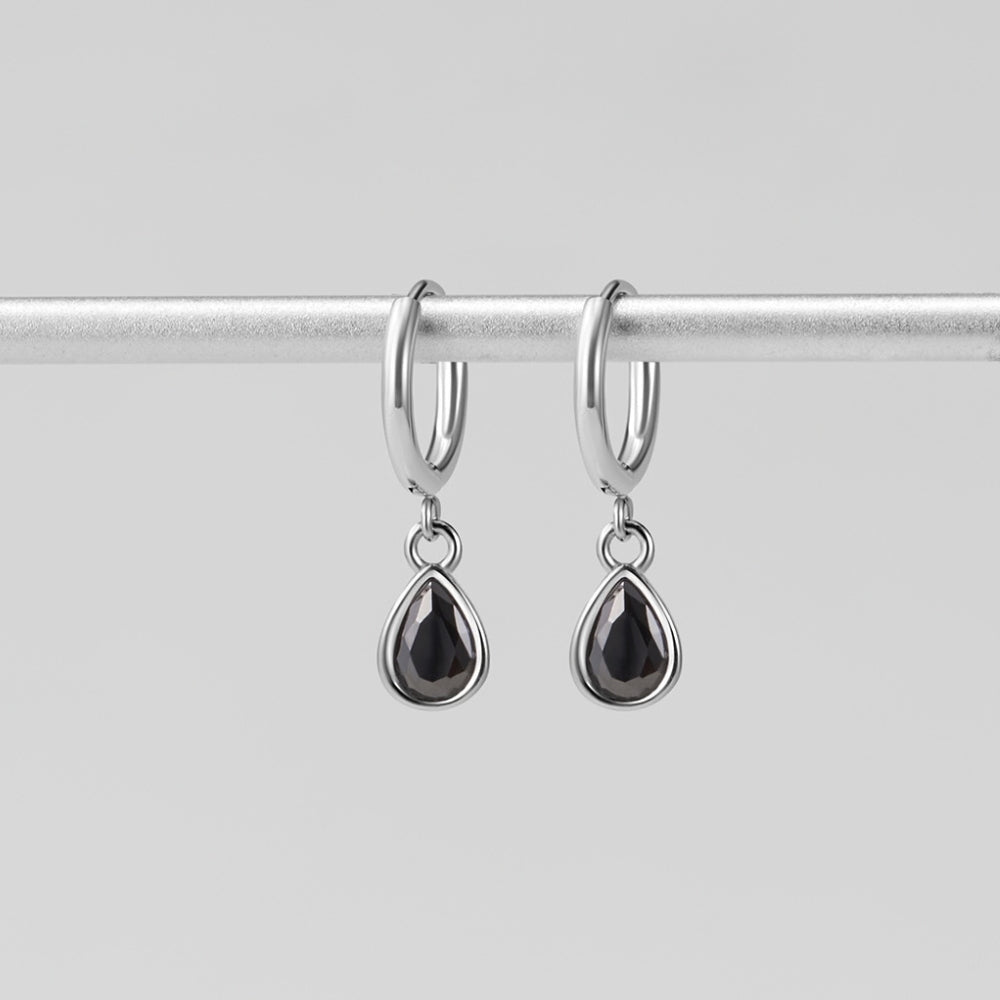 Silver Midnight Teardrop Earrings, hanging from a silver rod, black teardrop stones in silver