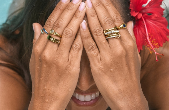 Alashan Stone Bead Necklace, worn at the neck with a gold hoop earring, close-up on skin