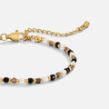 Alashan Monochrome Bead Bracelet, laid flat on a pale background, close-up of beaded links and