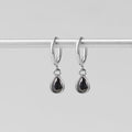 Silver Midnight Teardrop Earrings, hanging from a silver rod, black teardrop stones in silver