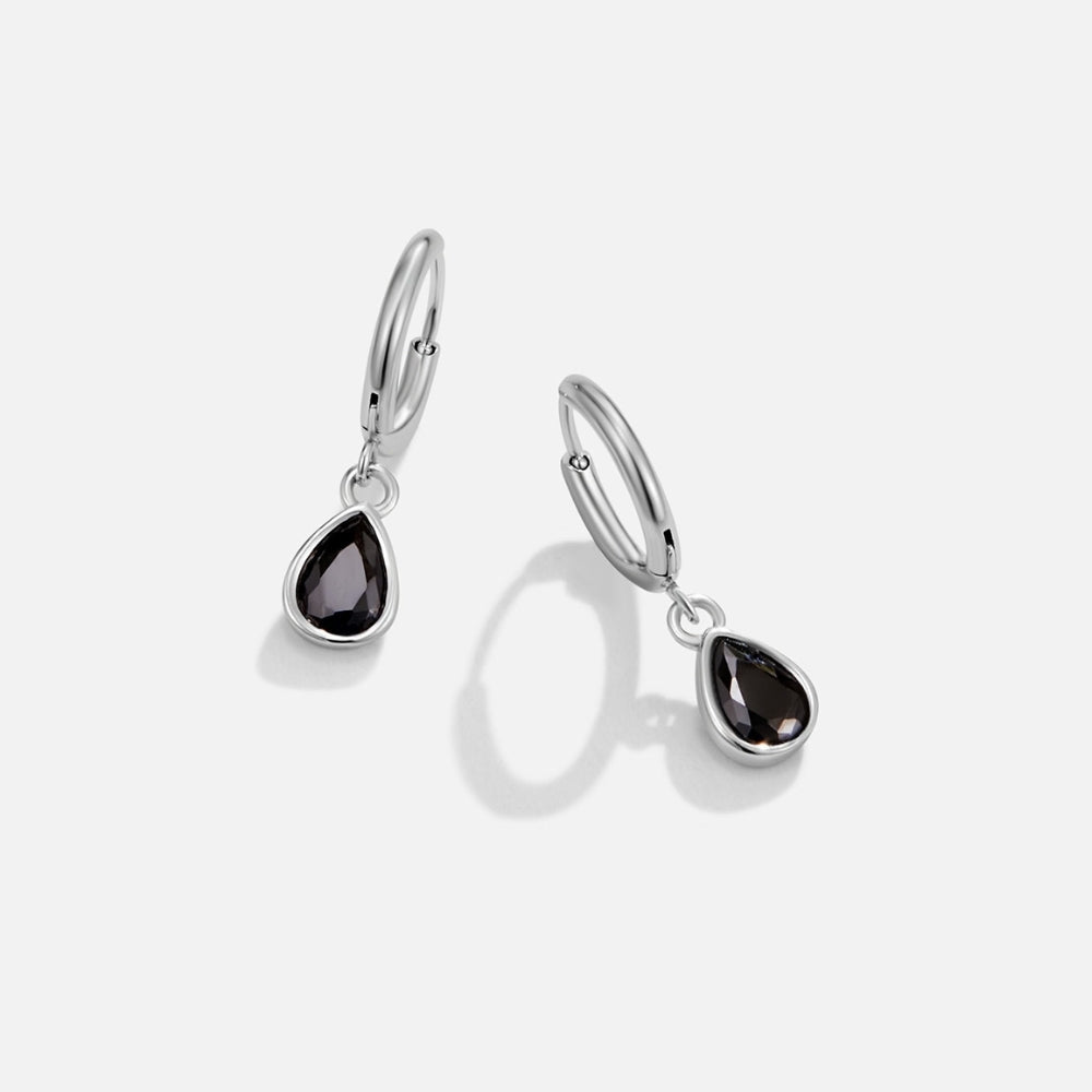 Silver Midnight Teardrop Earrings, pair of silver hoop earrings with dark teardrop stones, on white