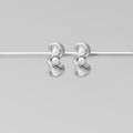 Tara Silver Entwined Pearl Earrings, a pair of silver earrings hanging on a silver rod, two
